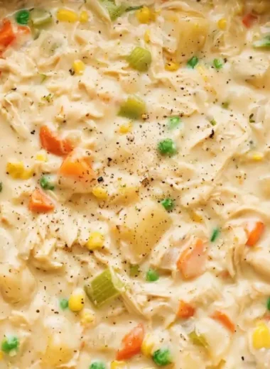 Delicious Chicken Pot Pie Soup in a bowl with vegetables and herbs