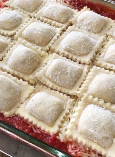 Cozy baked ravioli casserole with melted cheese and marinara sauce.