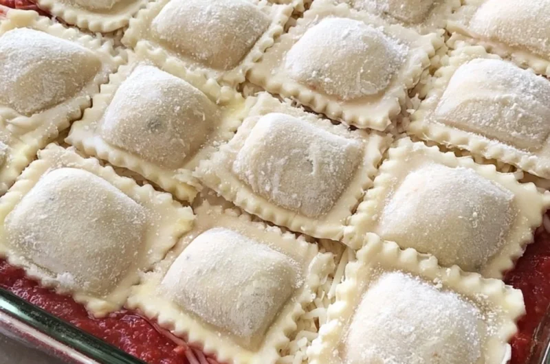 Cozy baked ravioli casserole with melted cheese and marinara sauce.