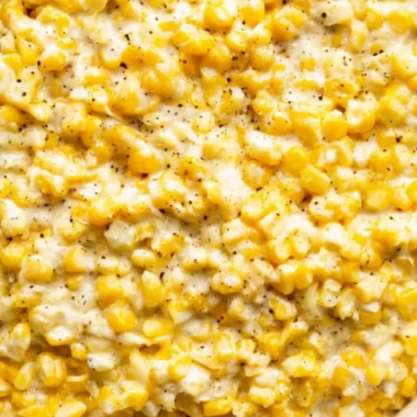 Delicious cozy creamed corn served in a bowl with a golden hue.