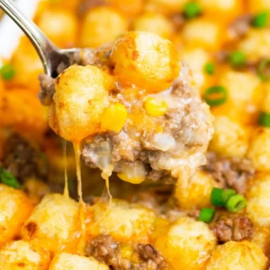 Delicious tater tot casserole topped with crispy tots and cheese, perfect for a cozy meal.