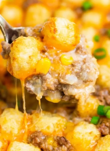 Delicious tater tot casserole topped with crispy tots and cheese, perfect for a cozy meal.