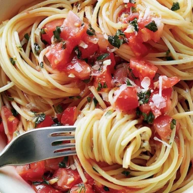 Cozy pasta topped with fresh tomato sauce served in a bowl