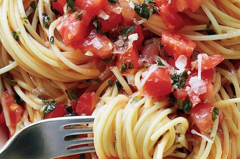 Cozy pasta topped with fresh tomato sauce served in a bowl