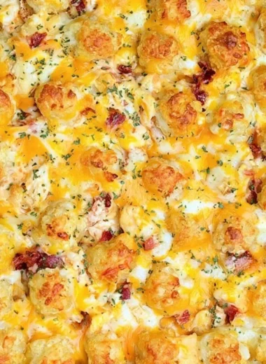 Cracked Out Chicken Tater Tot Casserole topped with cheese and crispy tater tots