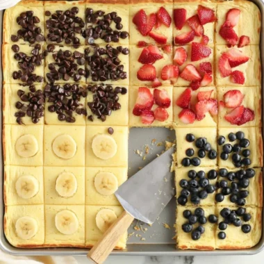 Fluffy sheet pan pancakes baked in a large pan for easy serving.