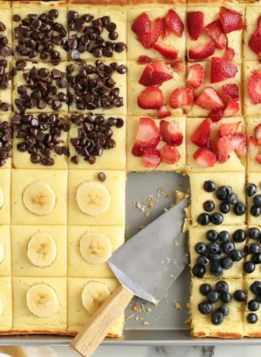 Fluffy sheet pan pancakes baked in a large pan for easy serving.