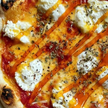 Hot honey ricotta pizza with fresh ingredients and drizzled honey