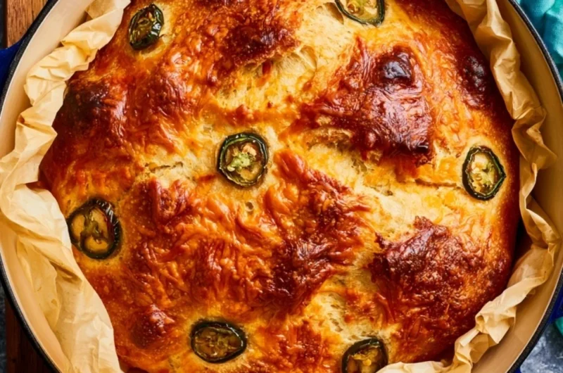 Loaf of jalapeno cheddar Dutch oven bread with a golden crust.