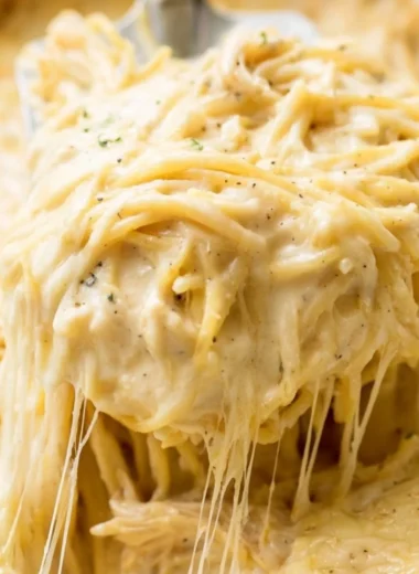 A bowl of creamy Ranch Chicken Spaghetti topped with herbs and cheese.