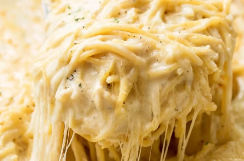 A bowl of creamy Ranch Chicken Spaghetti topped with herbs and cheese.