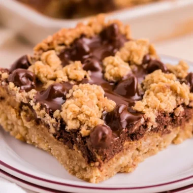 Cozy chocolate peanut butter oatmeal bars on a wooden table with a rustic background