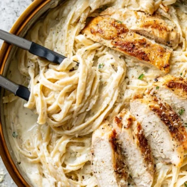 Creamy Chicken Fettuccine Alfredo served in a bowl with parsley garnish.